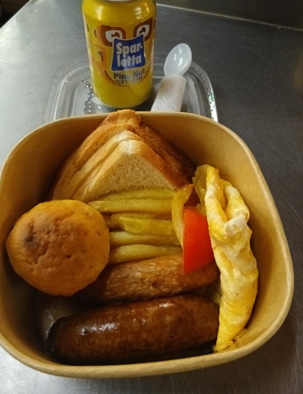 Takeaway breakfast box with sausages, chips and omelette